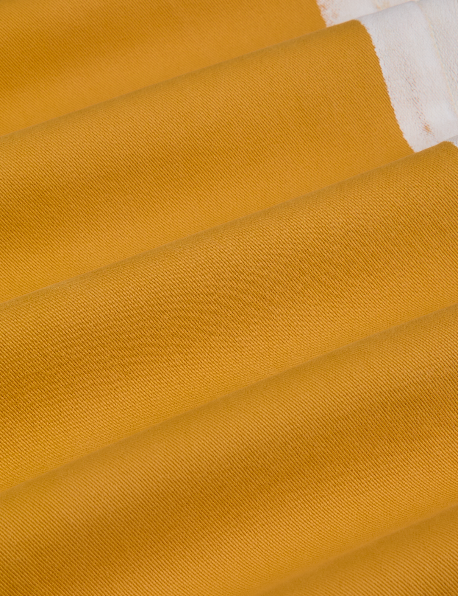 Painted Work Pants in Mustard Yellow fabric detail close up