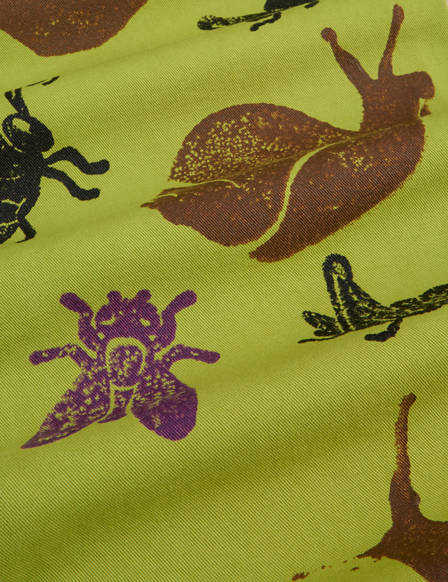 Paintstamped Work Pants in Froggy fabric close up of brown, black and purple bugs