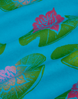 Paintstamped Work Pants in Lilypad fabric close up. Green stamped lilypads with pink flowers