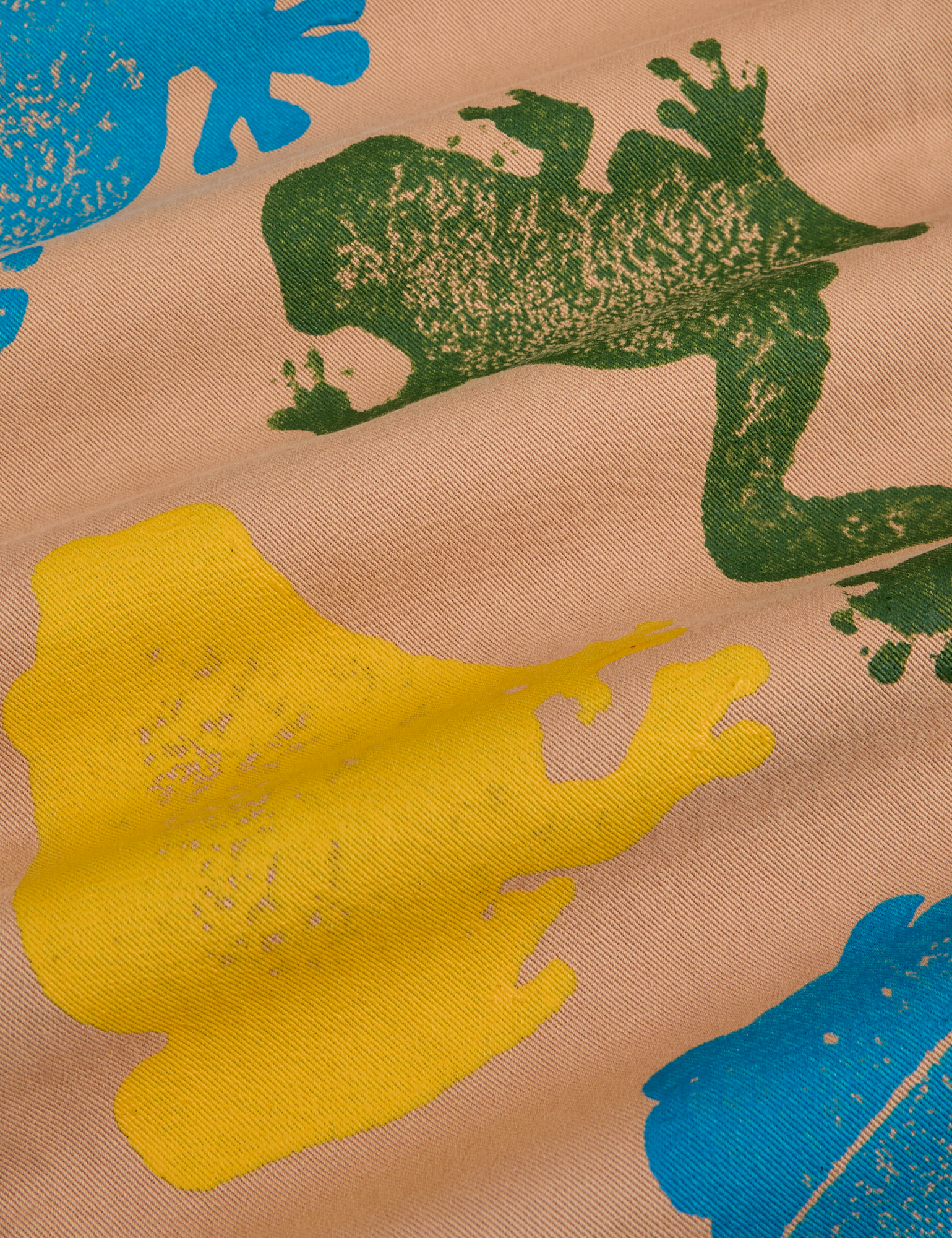 Paintstamped Work Pants in Froggy
fabric detail close up. Paintstamped green, blue and yellow frogs