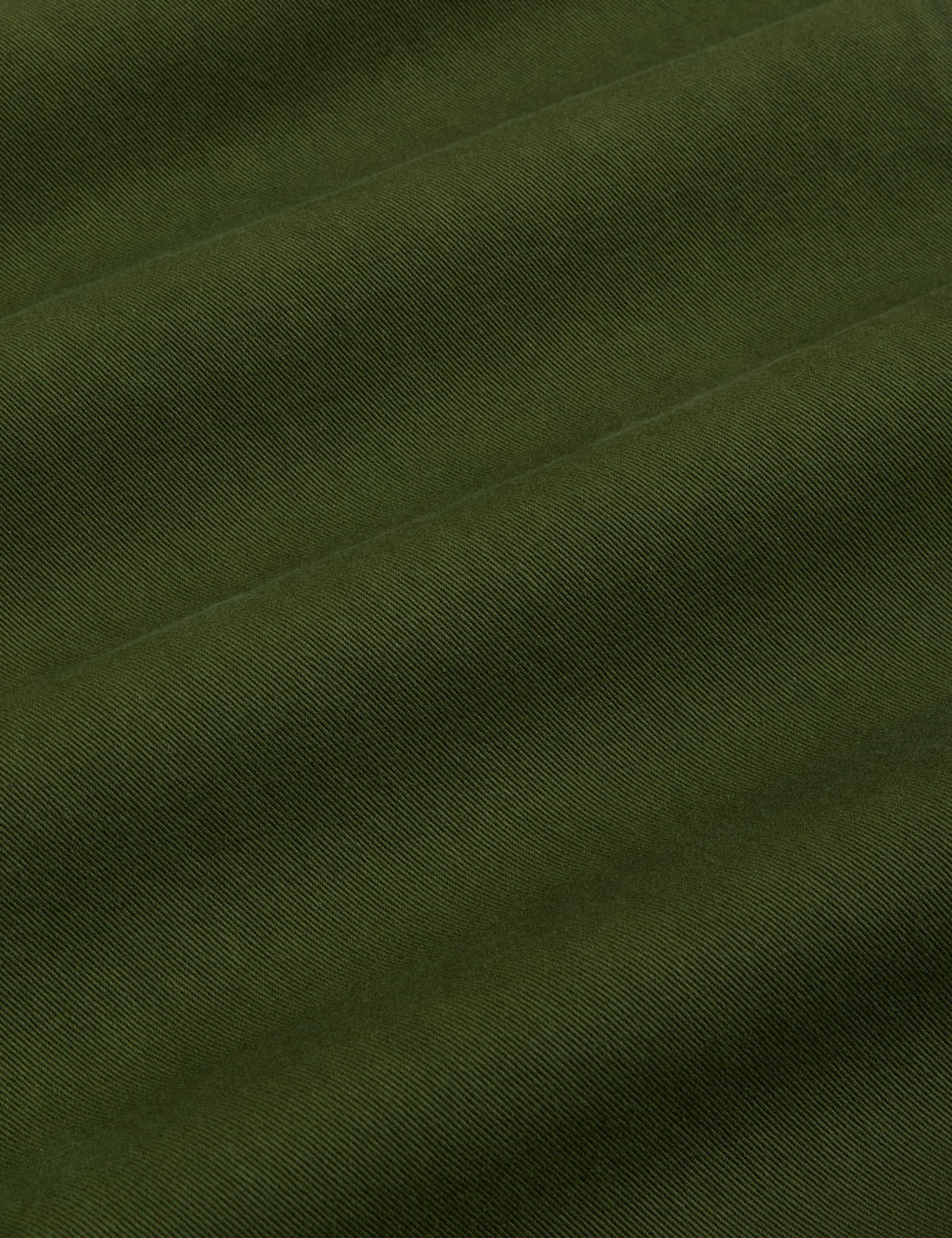 Baggy Mid-Rise Trousers in Evergreen fabric detail close up