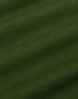Baggy Mid-Rise Trousers in Evergreen fabric detail close up
