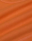 Contrast Stitch Mini Tank in Construction Orange fabric detail close up with white topstitching