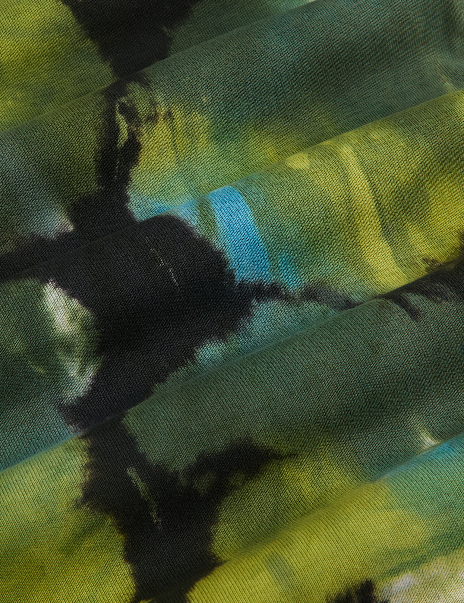 Long Sleeve Baby Tee in Green Pool fabric detail close up. Shades of Ggeen, blue and black tie dye