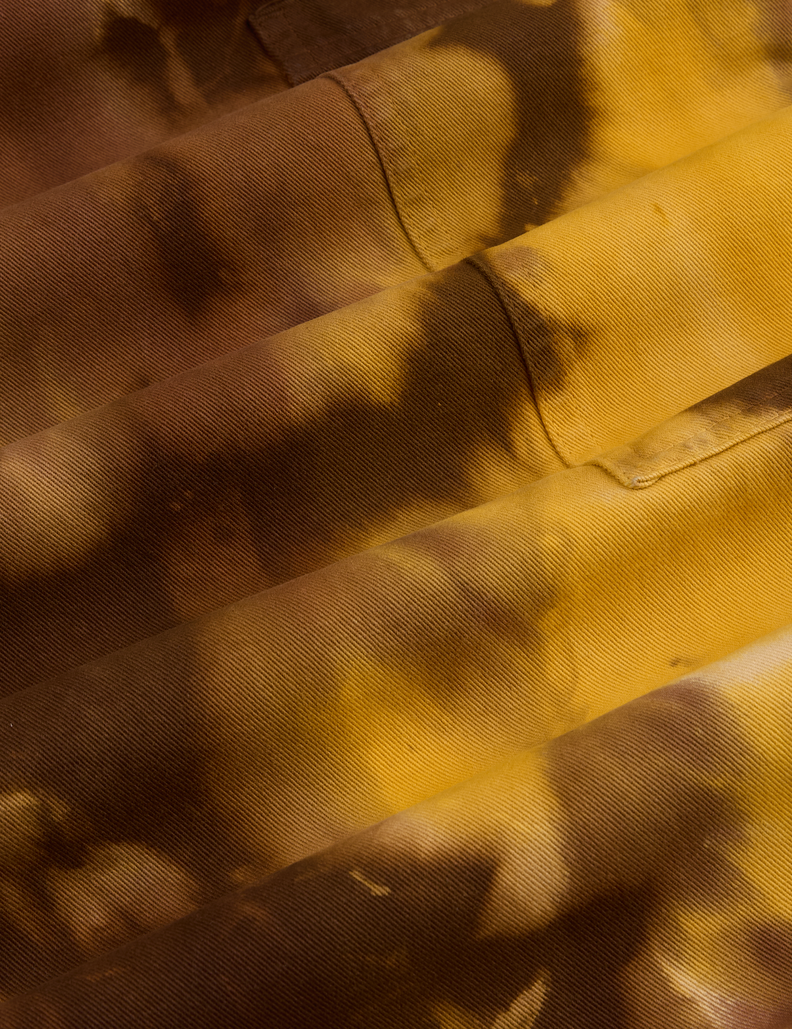 Magic Waters Drop Pocket Pants in Honey Brown fabric detail close up. Tie dye in shades of brown and yellow