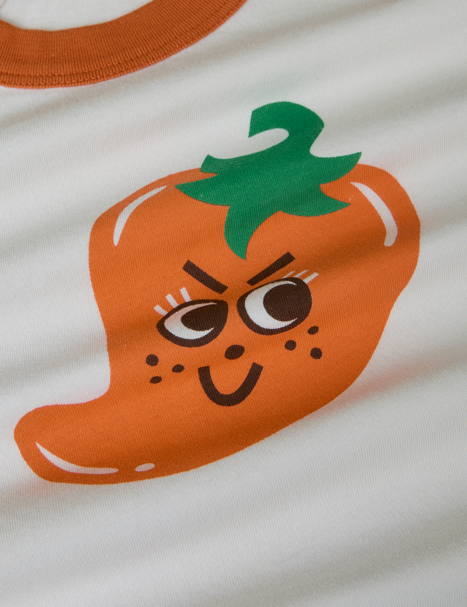 Produce Raglan Tee in Habanero. Illustrated Habanero pepper in orange with green stem