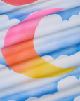 Airbrush Moon Vintage Tee fabric detail close up. Airbrush gradient moon in pink, orange and yellow. Blue skies and white clouds background