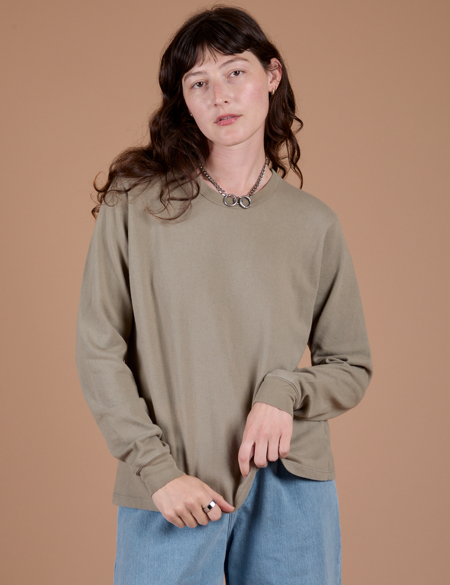 Alex is 5’8” and wearing P Long Sleeve Burly Tee in Khaki Grey