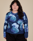 Ashley is 5’7” and wearing L Long Sleeve Baby Tee in Blue Magic Waters