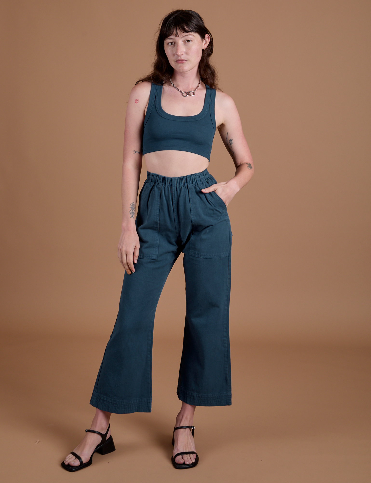 Alex is wearing Action Pants in Lagoon and Mini Tank in Lagoon