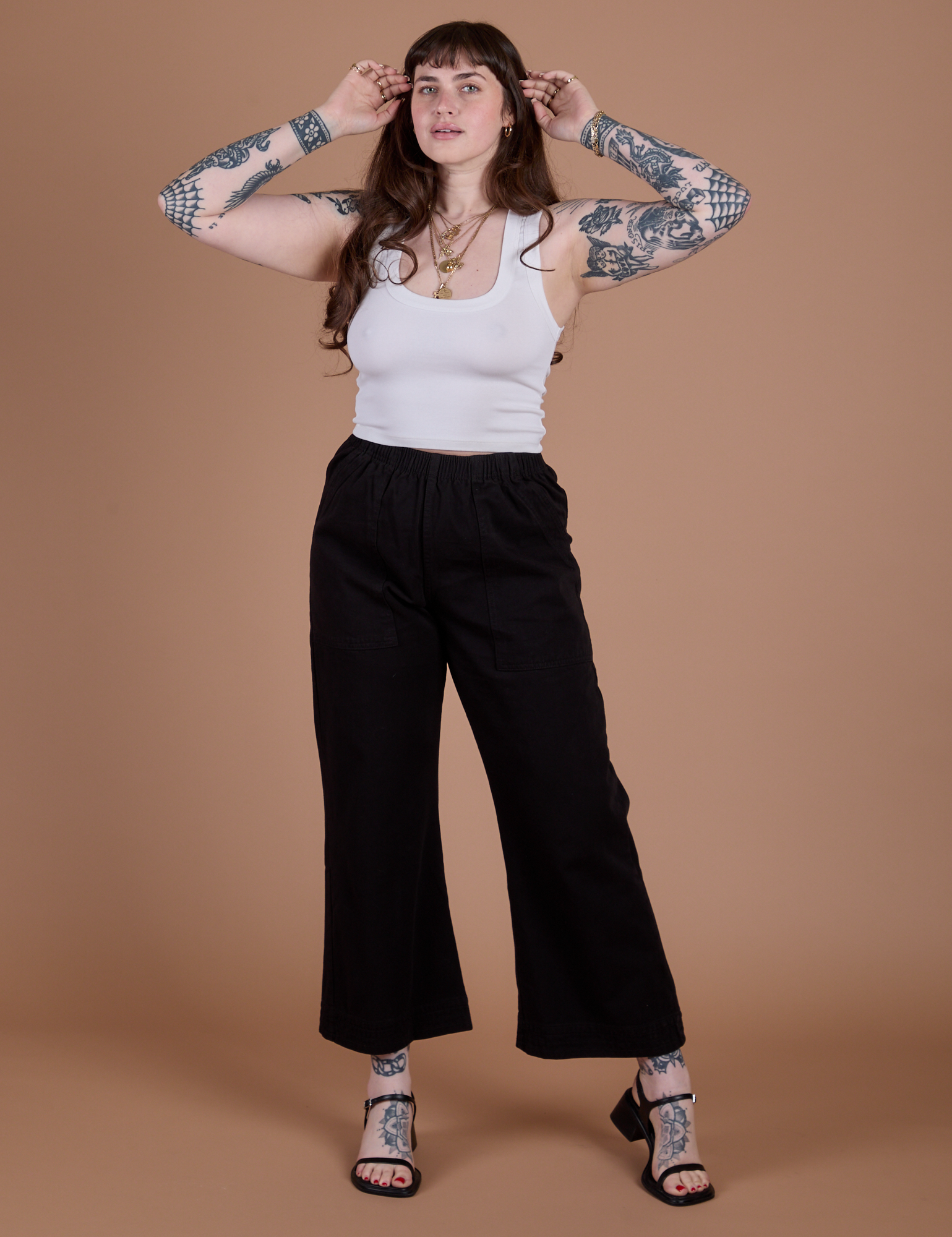 Sydney is wearing  Action Pants in Basic Black and Cropped Tank in Vintage Tee White