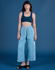 Alex is wearing Painted Drop Pocket Cargo Pants in Baby Blue and Mini Tank in Lagoon