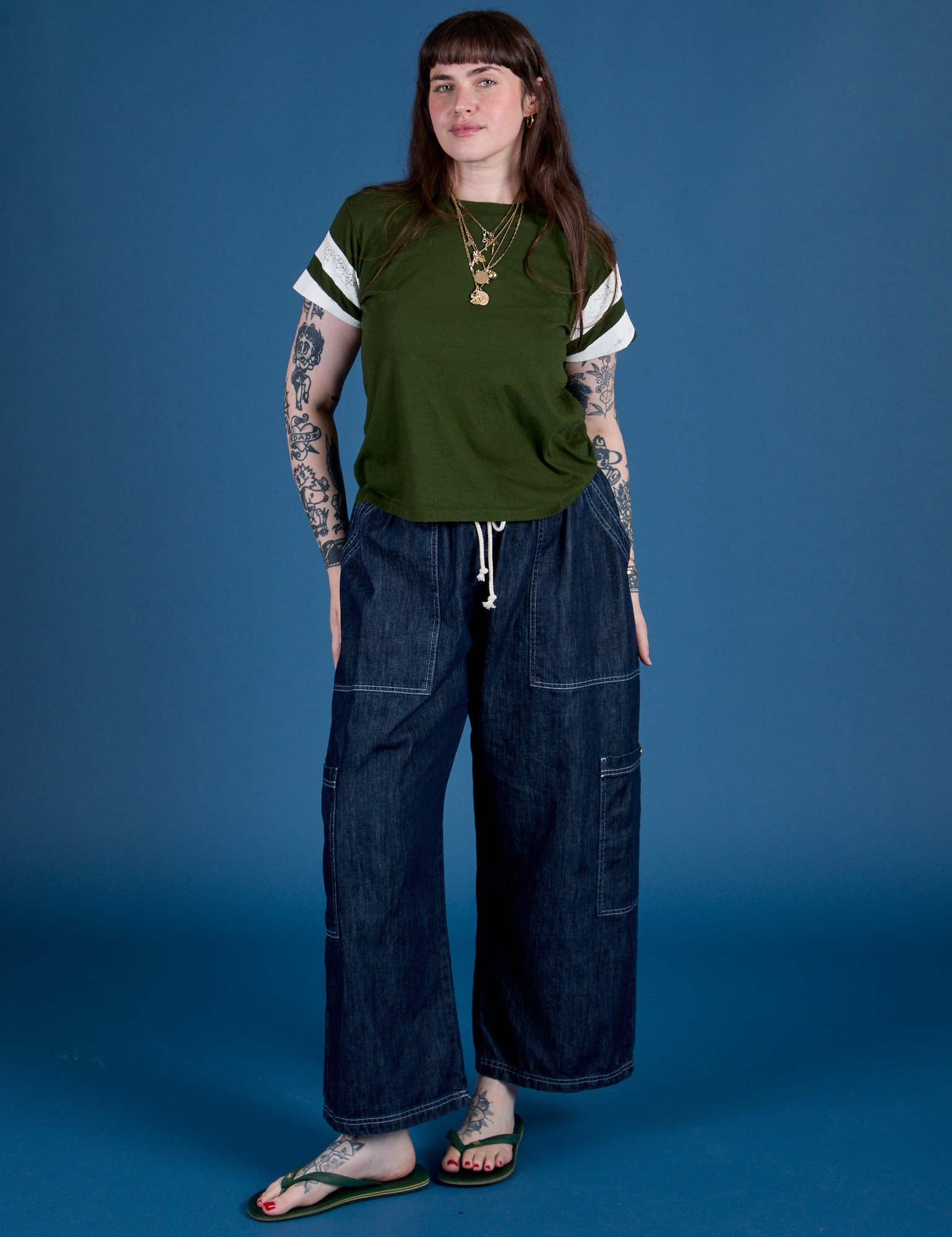 Sydney is wearing Painted Vintage Tee in Evergreen and dark wash Drop Pocket Cargo Pants