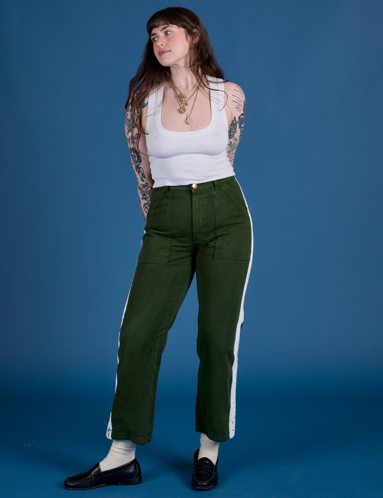 Sydney is wearing Painted Work Pants in Evergreen and vintage tee white Cropped Tank