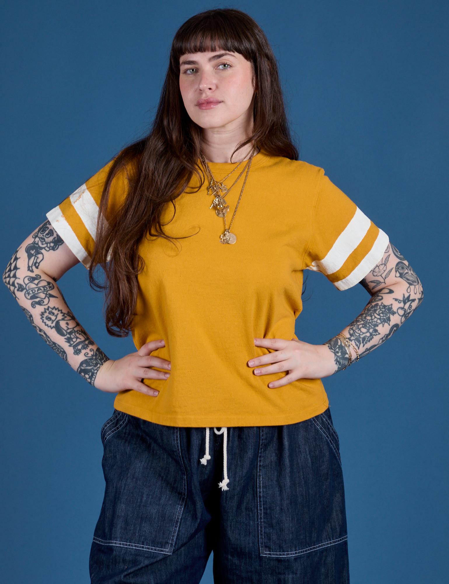 Sydney is 5’9” and wearing XXS Painted Burly Tee in Mustard Yellow