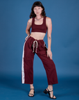 Alex is wearing Painted Drop Pocket Cargo Pants in Red Wine and matching Mini Tank