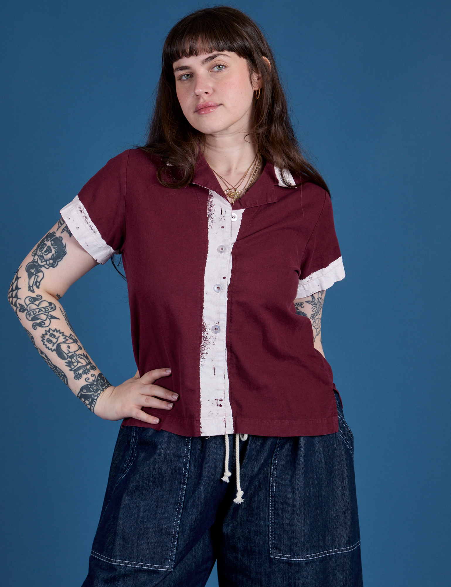 Sydney is wearing a buttoned up Painted Pantry Button-Up in Red Wine