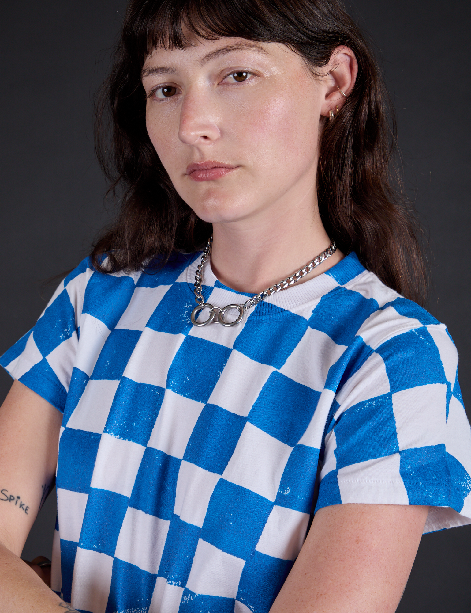 Angled front view close up of Checker Organic Tee in Blue on Alex