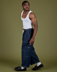 Side view of Denim Drop Pocket Pants in Dark Wash and Cropped Tank in Vintage Tee White on Isaac