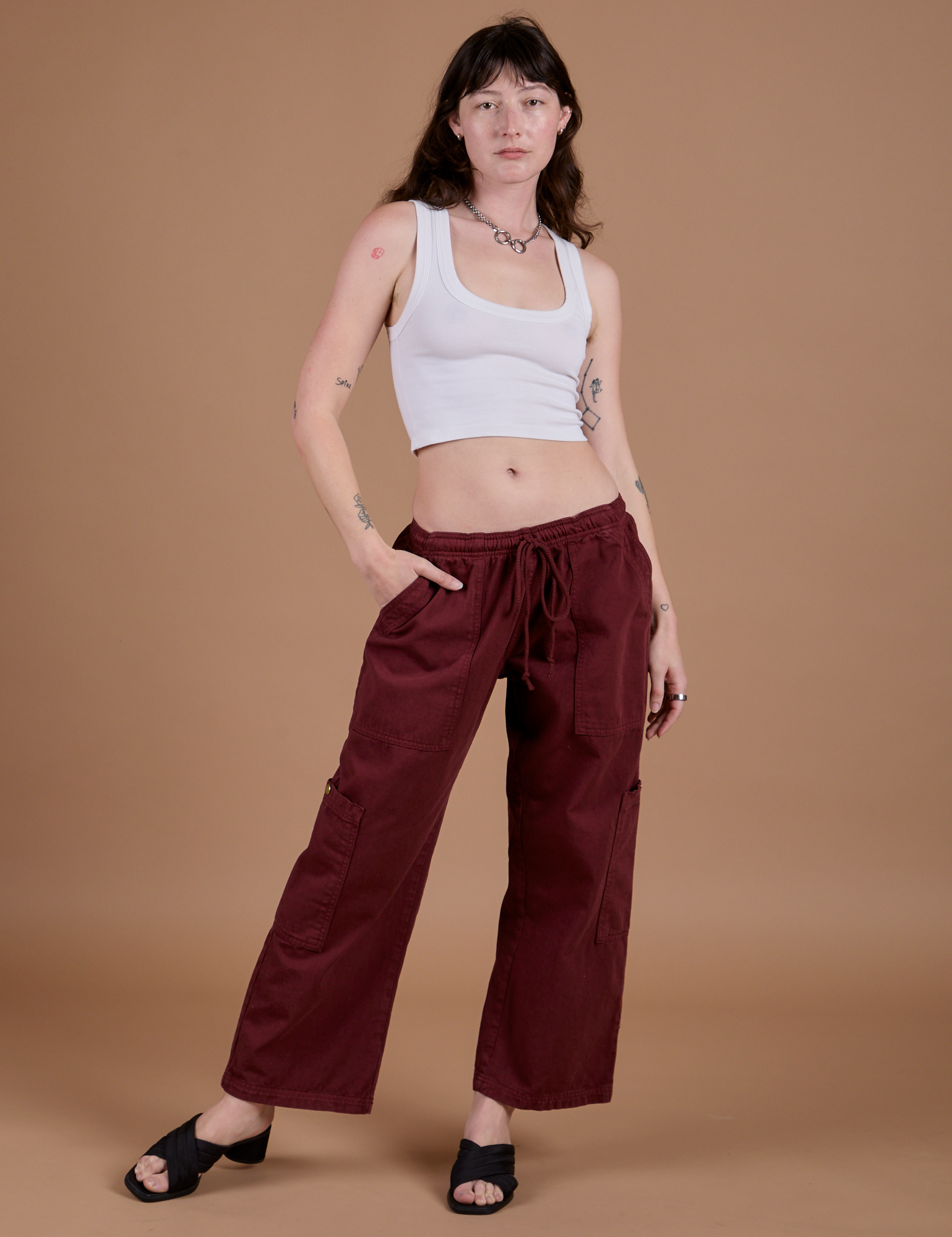 Alex is wearing Drop Pocket Cargo Pants in Red Wine and Cropped Tank in Vintage Tee White