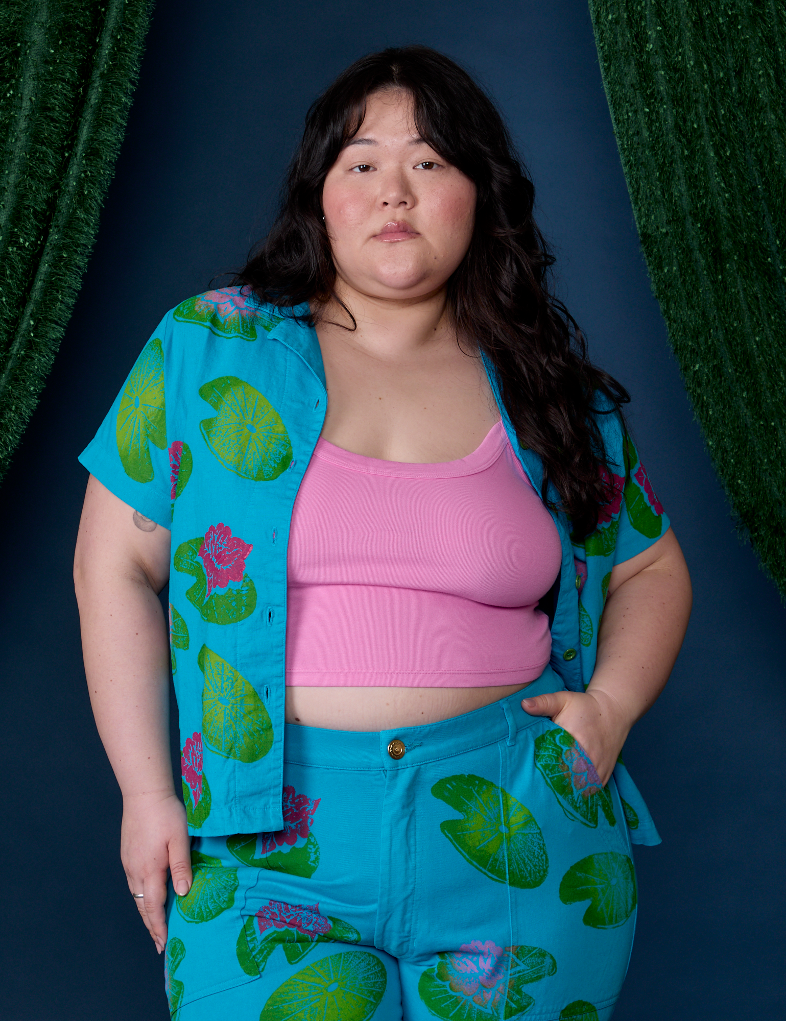 Ashley is wearing Paintstamped Pantry Button-Up in Lilypad with a bubblegum pink Cami underneath