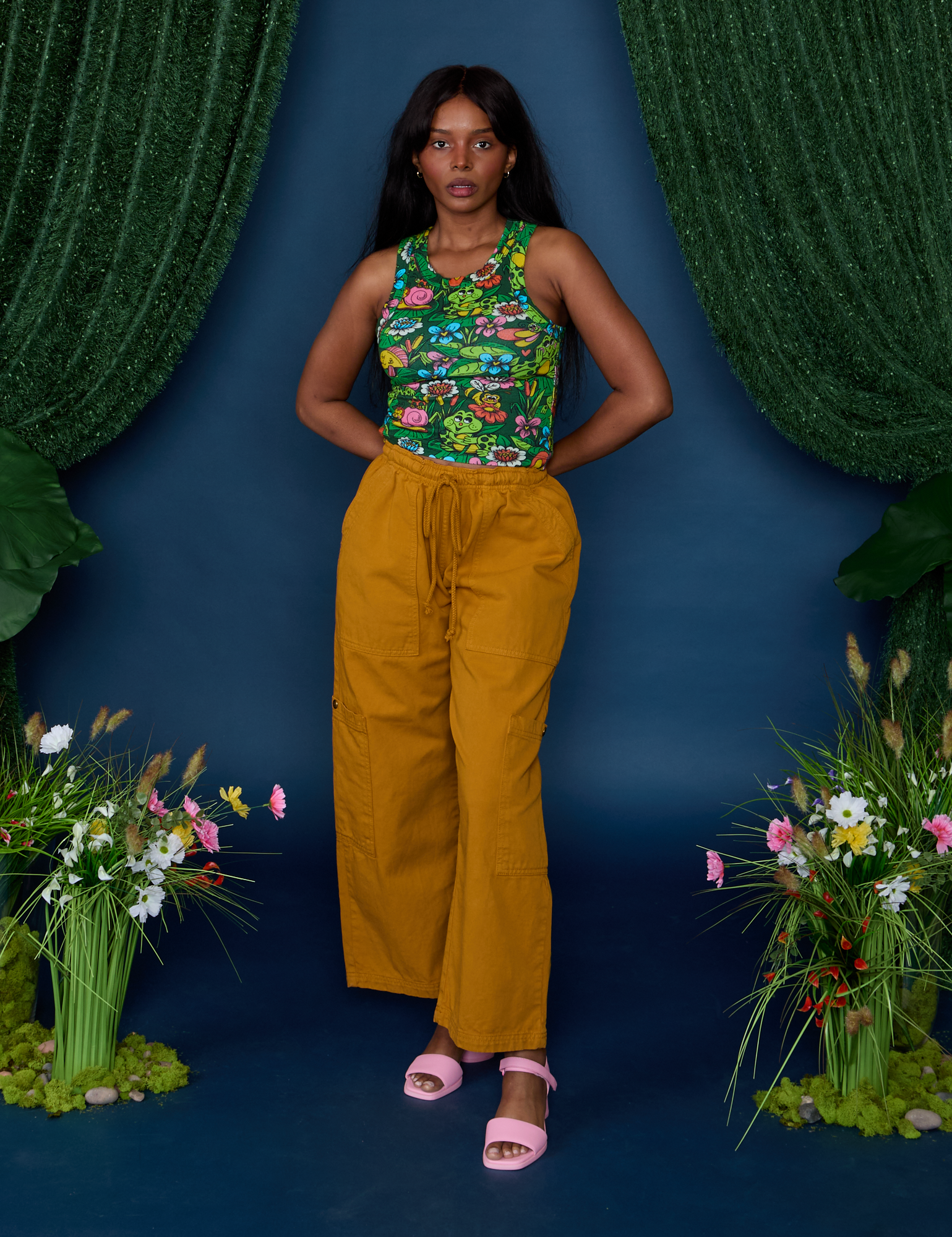 Kandia is wearing Pond Party Racerback Tank tucked into spicy mustard Drop Pocket Pants