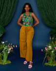 Kandia is wearing Pond Party Racerback Tank tucked into spicy mustard Drop Pocket Pants