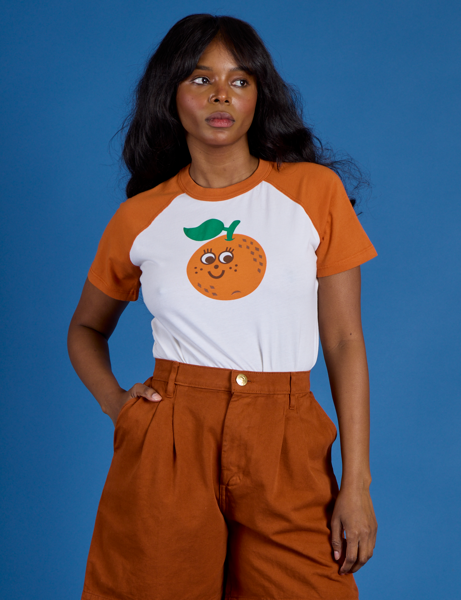 Kandia is 5’3” and wearing P Produce Raglan Tee in Orange