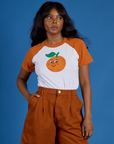 Kandia is 5’3” and wearing P Produce Raglan Tee in Orange