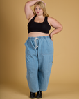 Juliet is wearing Contrast Stitch Mini Tank in Basic Black and light wash Drop Pocket Pants