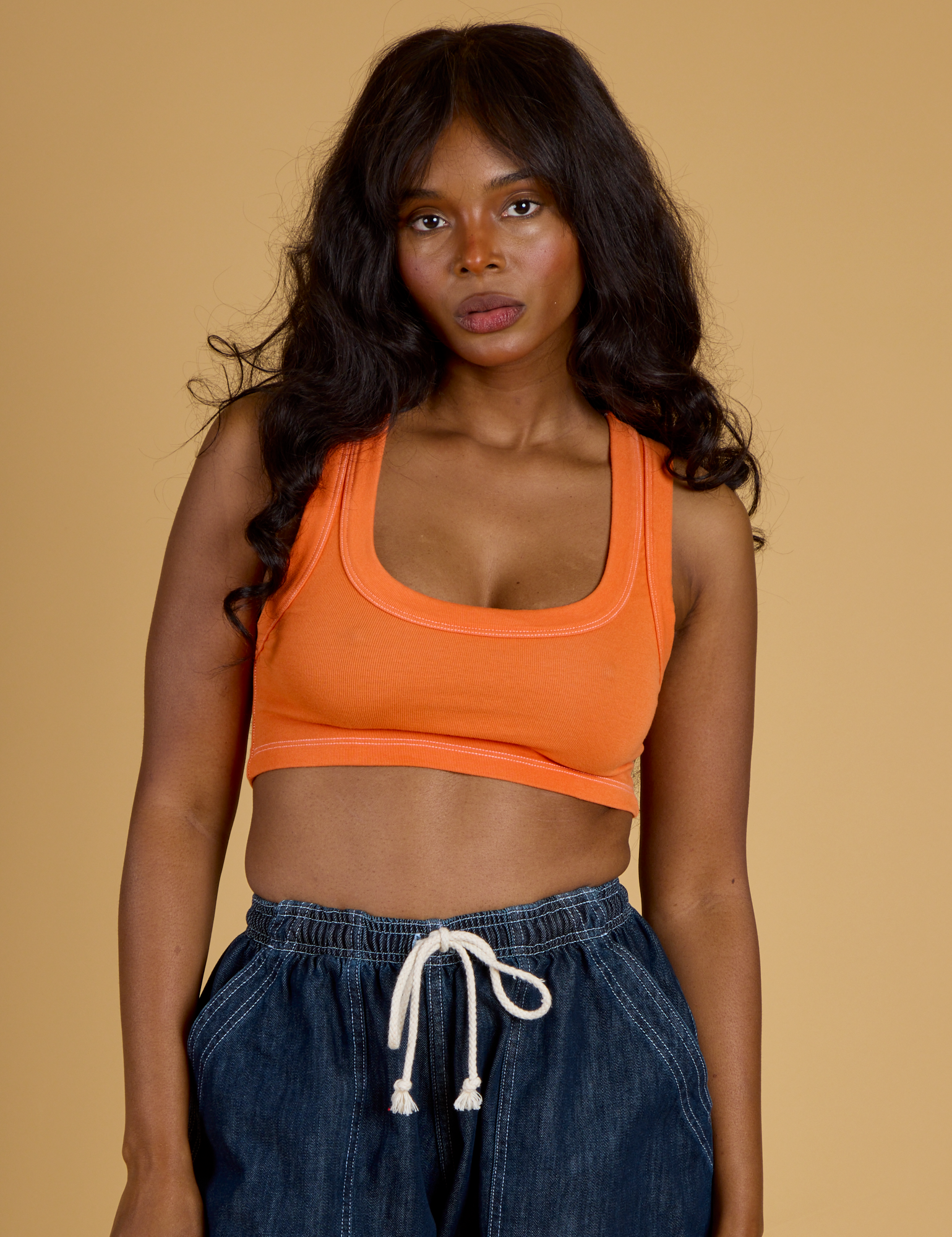 Kandia is 5’3” and wearing P Contrast Stitch Mini Tank in Construction Orange