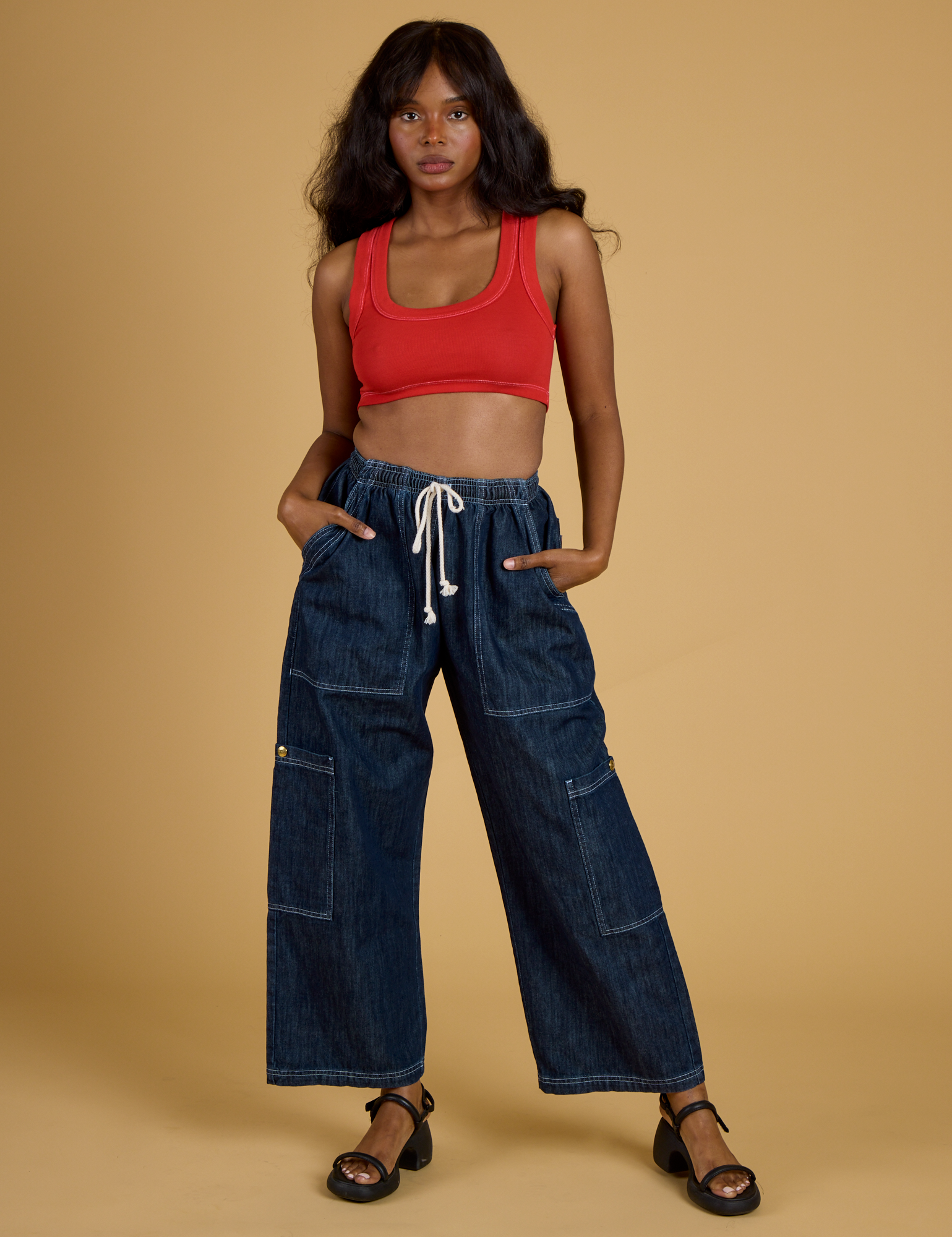 Kandia is wearing Contrast Stitch Mini Tank in Mustang Red and dark wash Denim Drop Pocket Pants