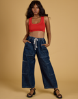 Kandia is wearing Contrast Stitch Mini Tank in Mustang Red and dark wash Denim Drop Pocket Pants