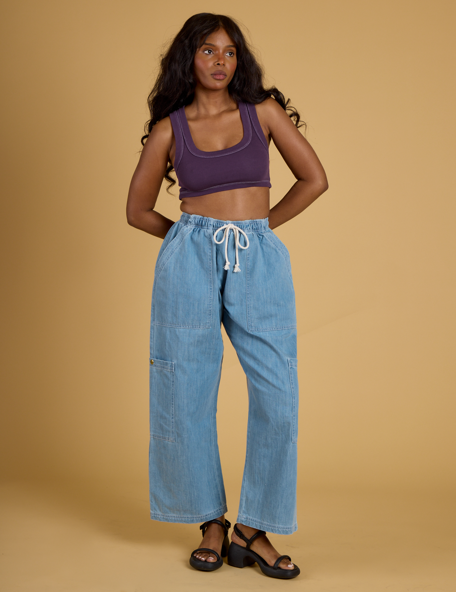 Kandia is wearing Contrast Stitch Mini Tank in Nebula Purple paired with light wash Denim Drop Pocket Pants