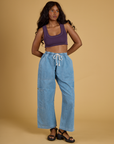 Kandia is wearing Contrast Stitch Mini Tank in Nebula Purple paired with light wash Denim Drop Pocket Pants