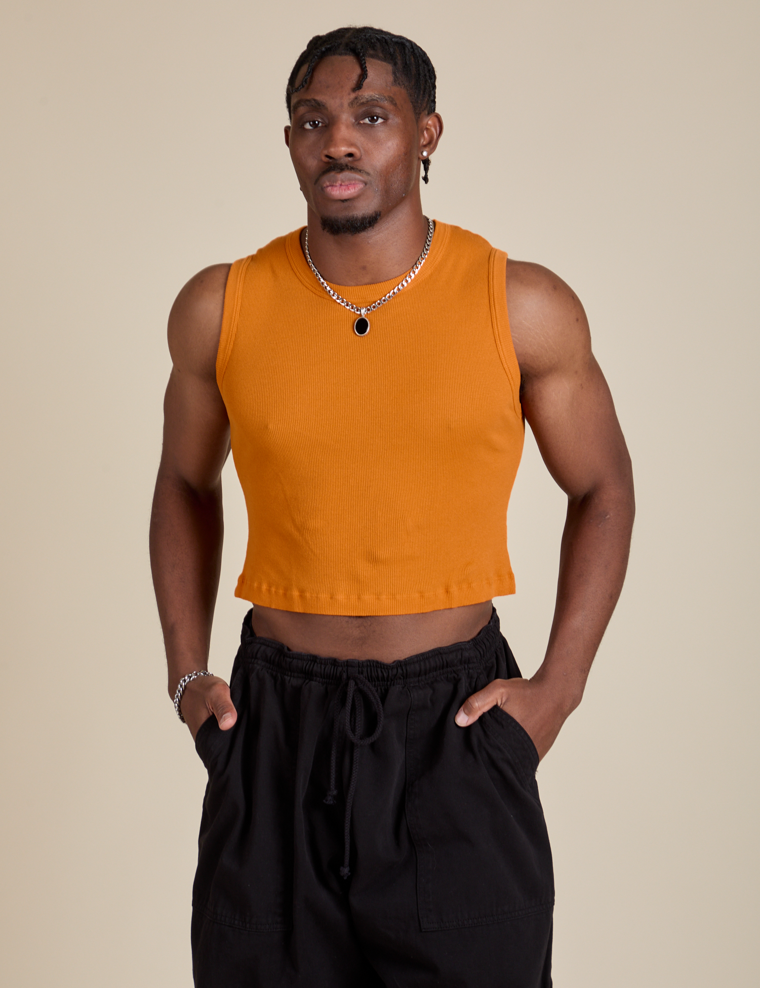 Isaac is 5’10” and wearing S Muscle Tee in Creamsicle Orange
