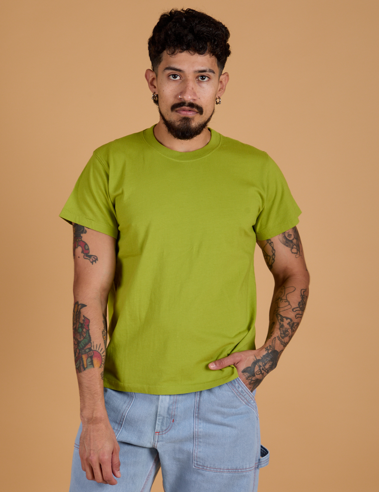 Jesse is wearing Organic Vintage Tee in Gross Green