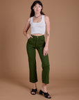 Alex is wearing Organic Work Pants in Evergreen and vintage tee white Cropped Tank