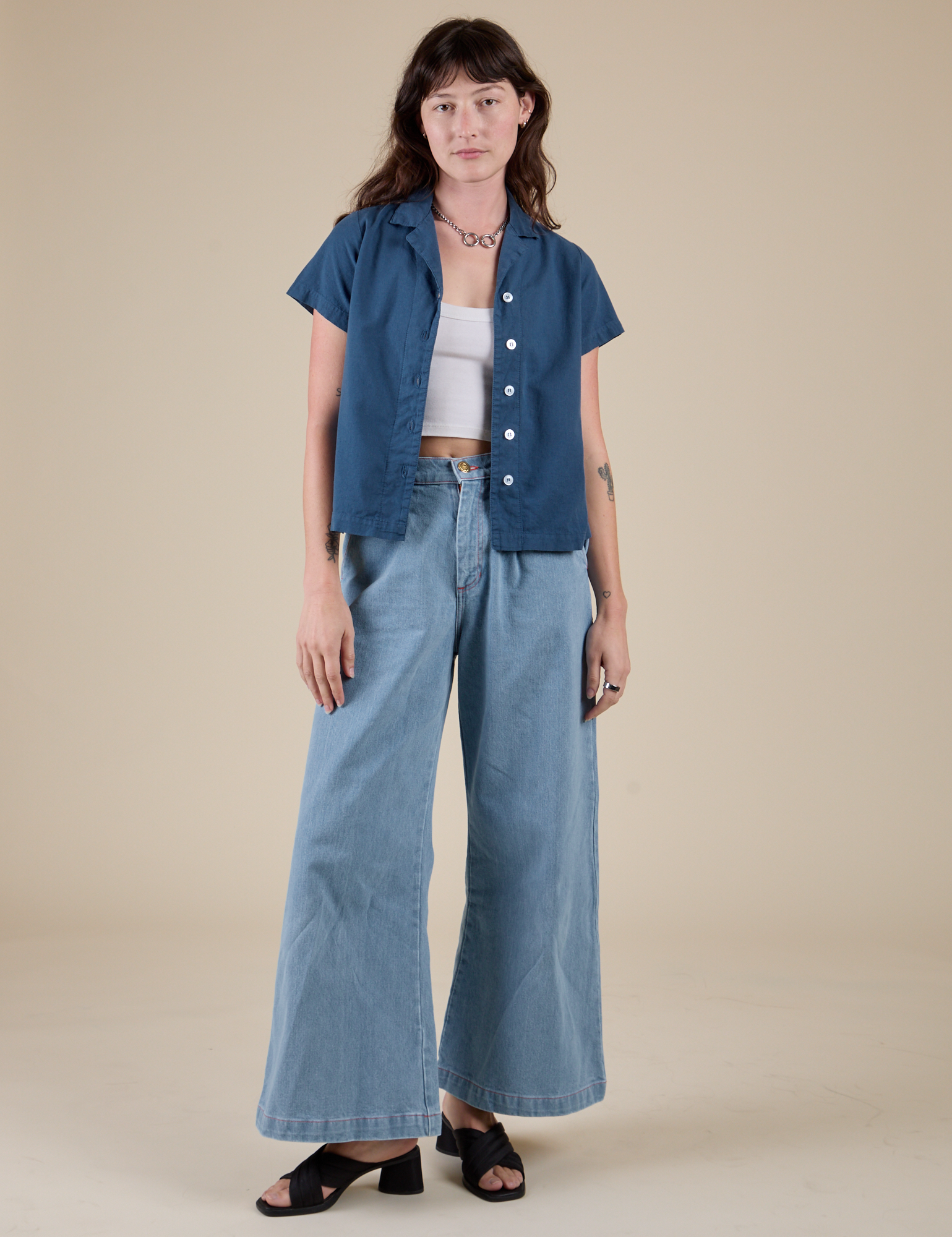 Alex is wearing Pantry Button-Up in French Blue and light wash Indigo Wide Leg Trousers