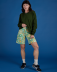 Alex is wearing Longline Work Shorts in Spring Quilt Print and evergreen Long Sleeve Burly Tee