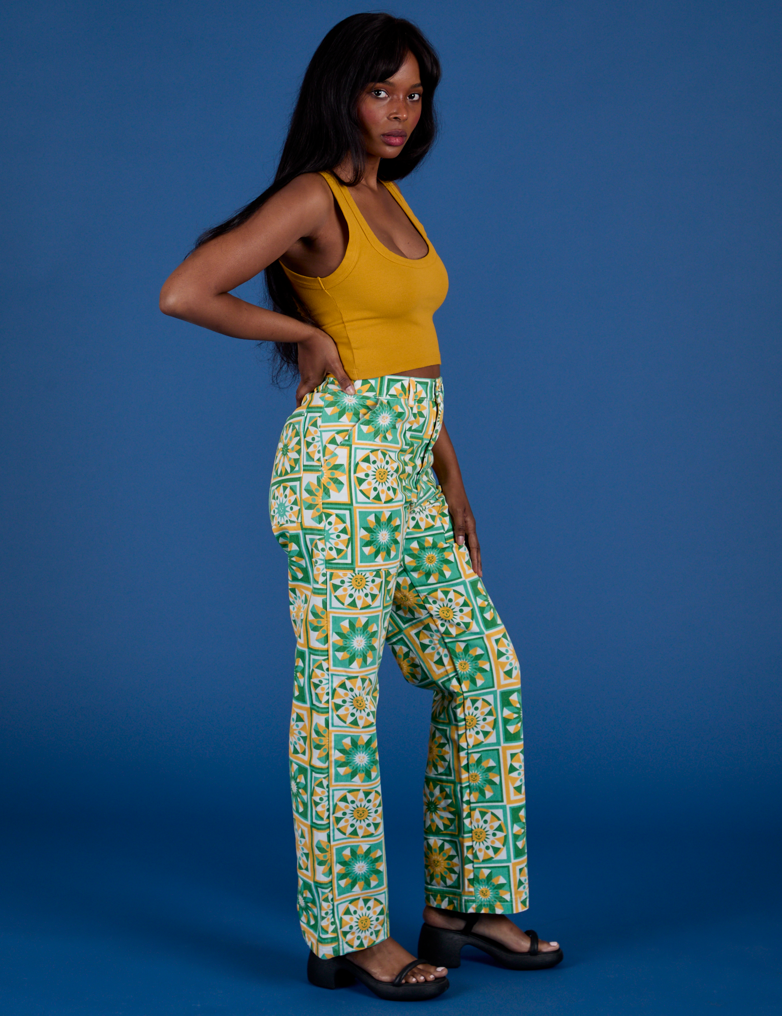 Side view of Work Pants in Spring Quilt Print and Cropped tank in Mustard Yellow on Kandia