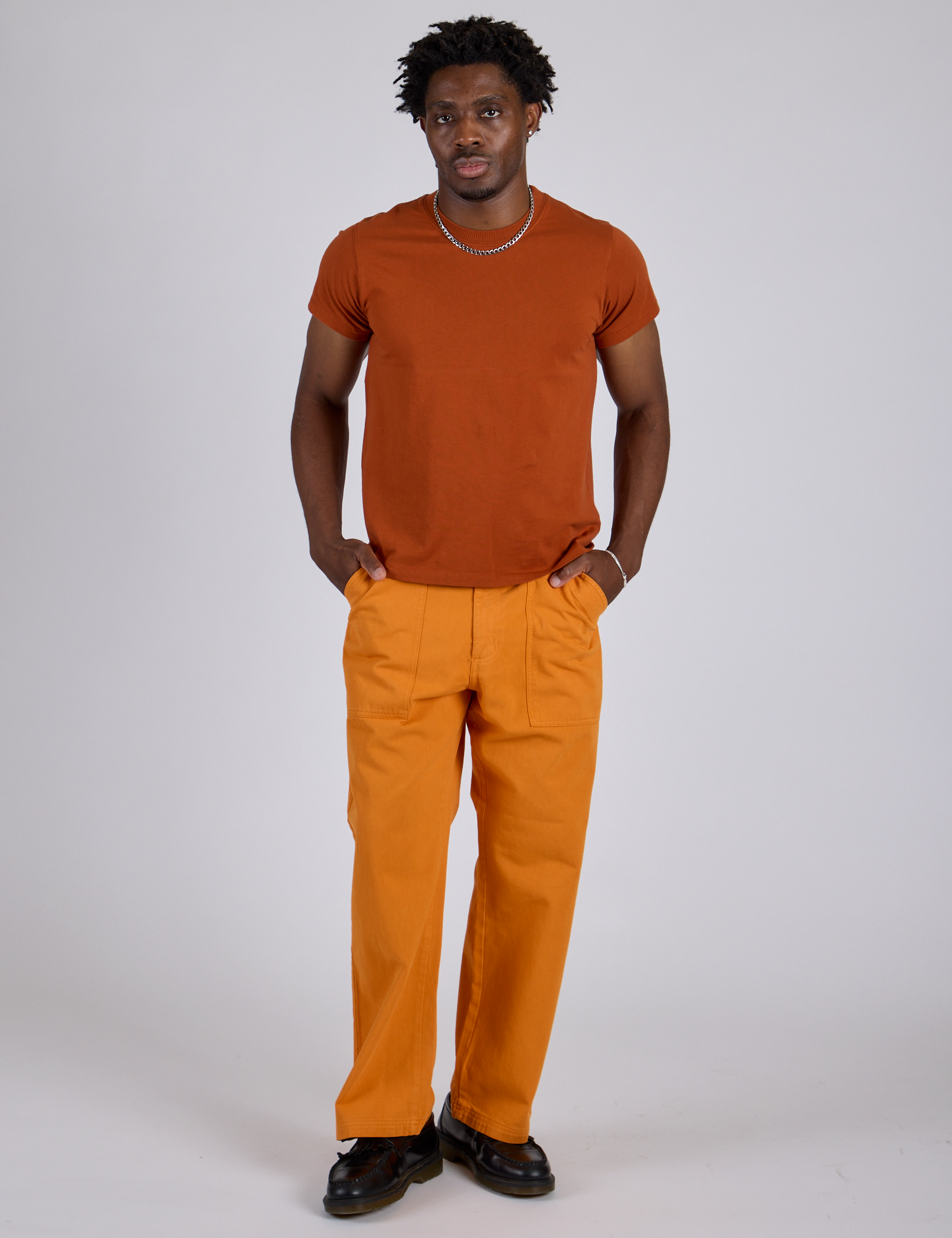 Isaac is 5’10” and wearing M Work Pants in Creamsicle Orange paired with burnt terracotta Organic Vintage Tee