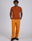 Isaac is 5’10” and wearing M Work Pants in Creamsicle Orange paired with burnt terracotta Organic Vintage Tee