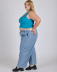 Side view of Cropped Tank Top in Hawaiian Blue and light wash Denim Drop Pocket Pants