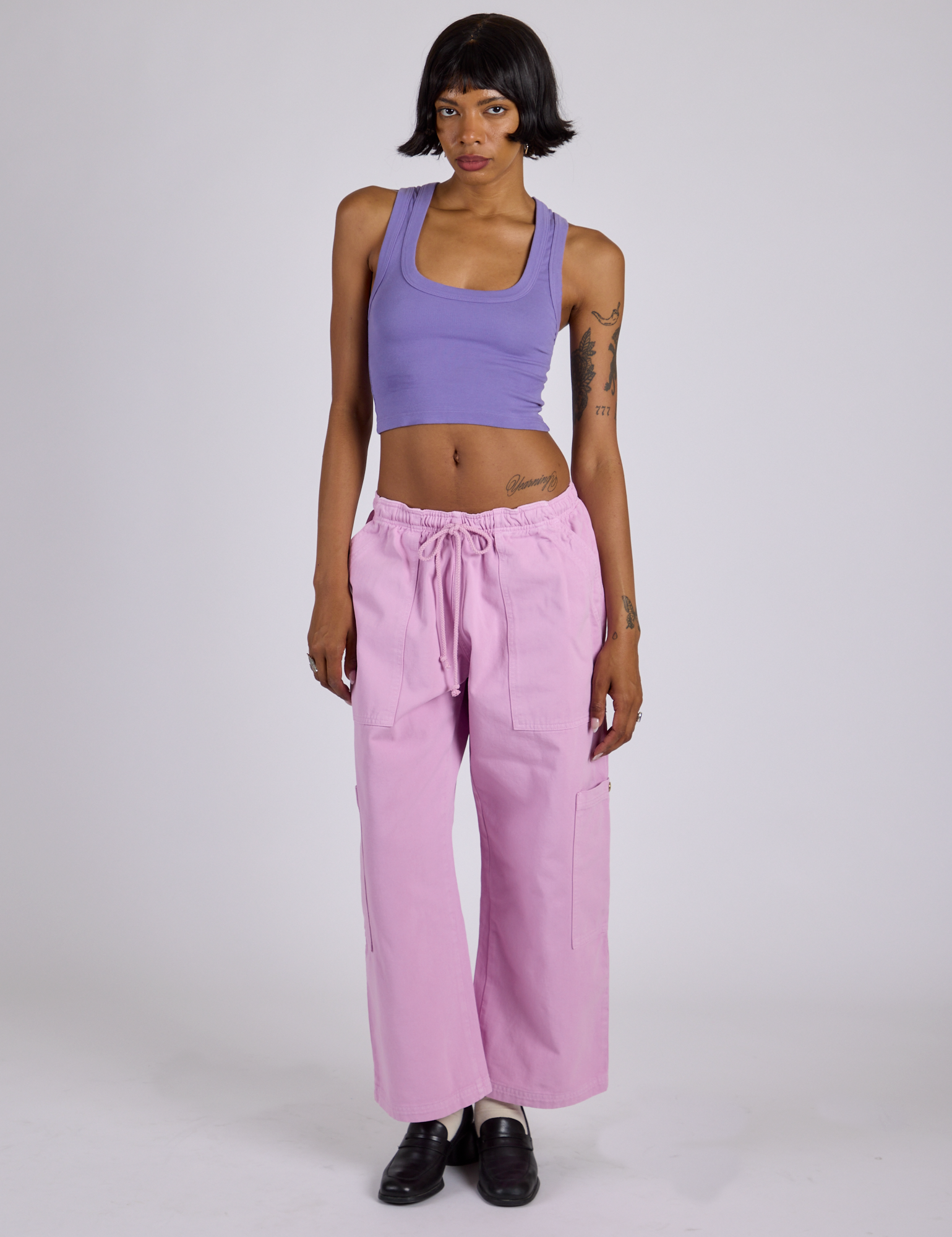 Kira is wearing Drop Pocket Cargo Pants in Lilac Purple and Cropped Tank in Faded Grape