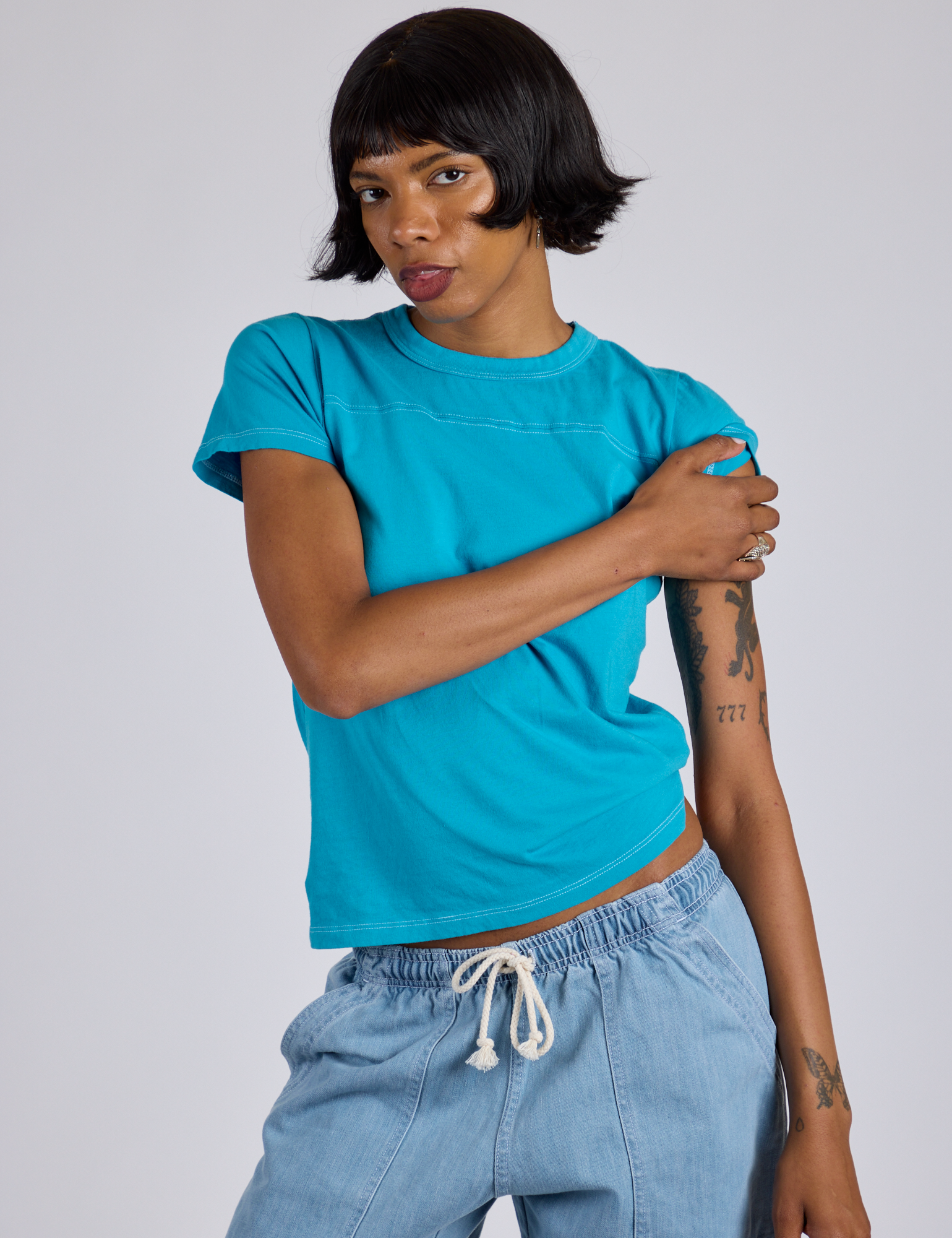 Kira is wearing Jr. Varsity Tee in Hawaiian Blue