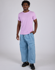 Isaac is wearing Jr. Varsity Tee in Lilac Purple and light wash Denim Drop Pocket Pants
