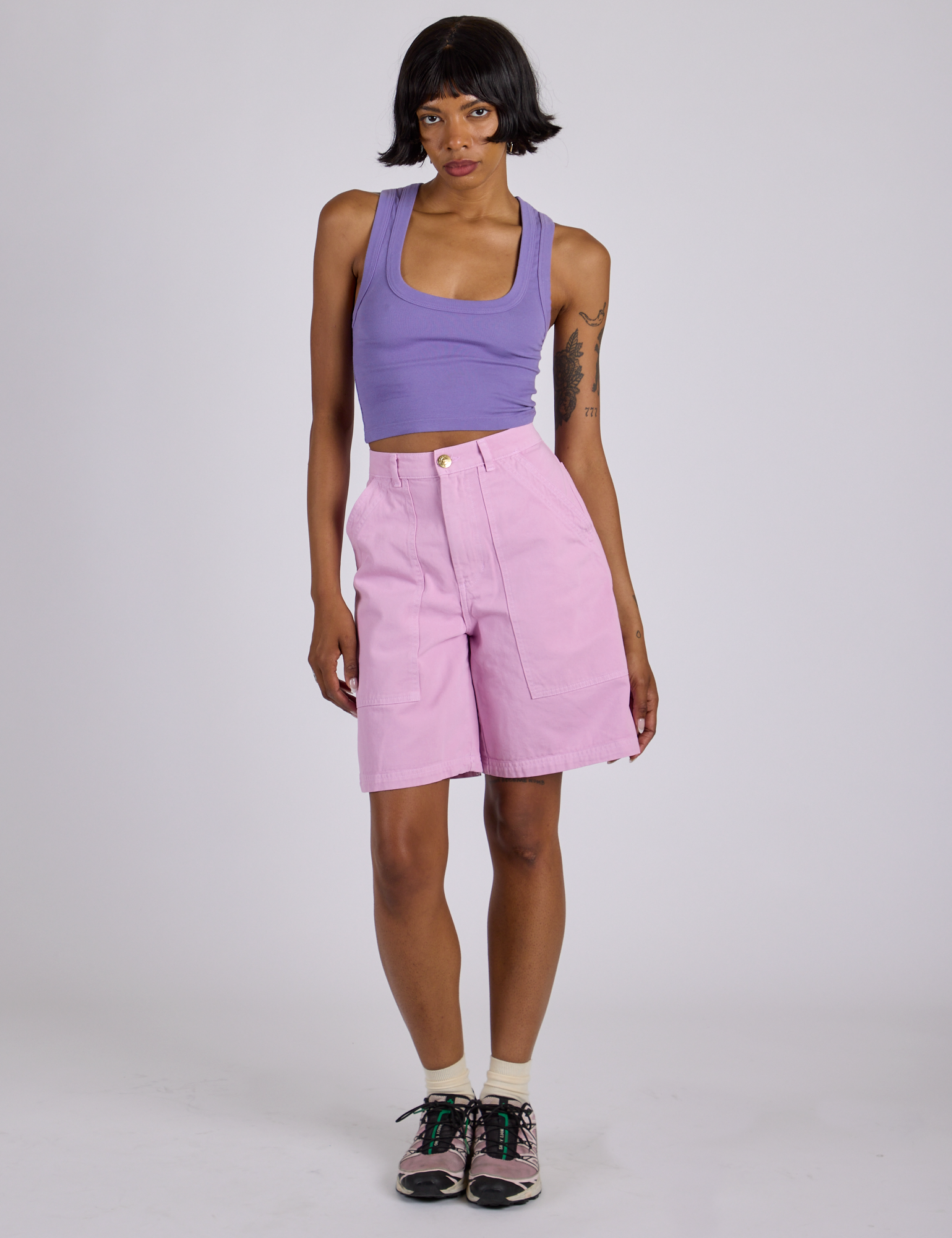 Kira is wearing Longline Work Shorts in Lilac Purple and faded grape Cropped Tank