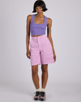 Kira is wearing Longline Work Shorts in Lilac Purple and faded grape Cropped Tank