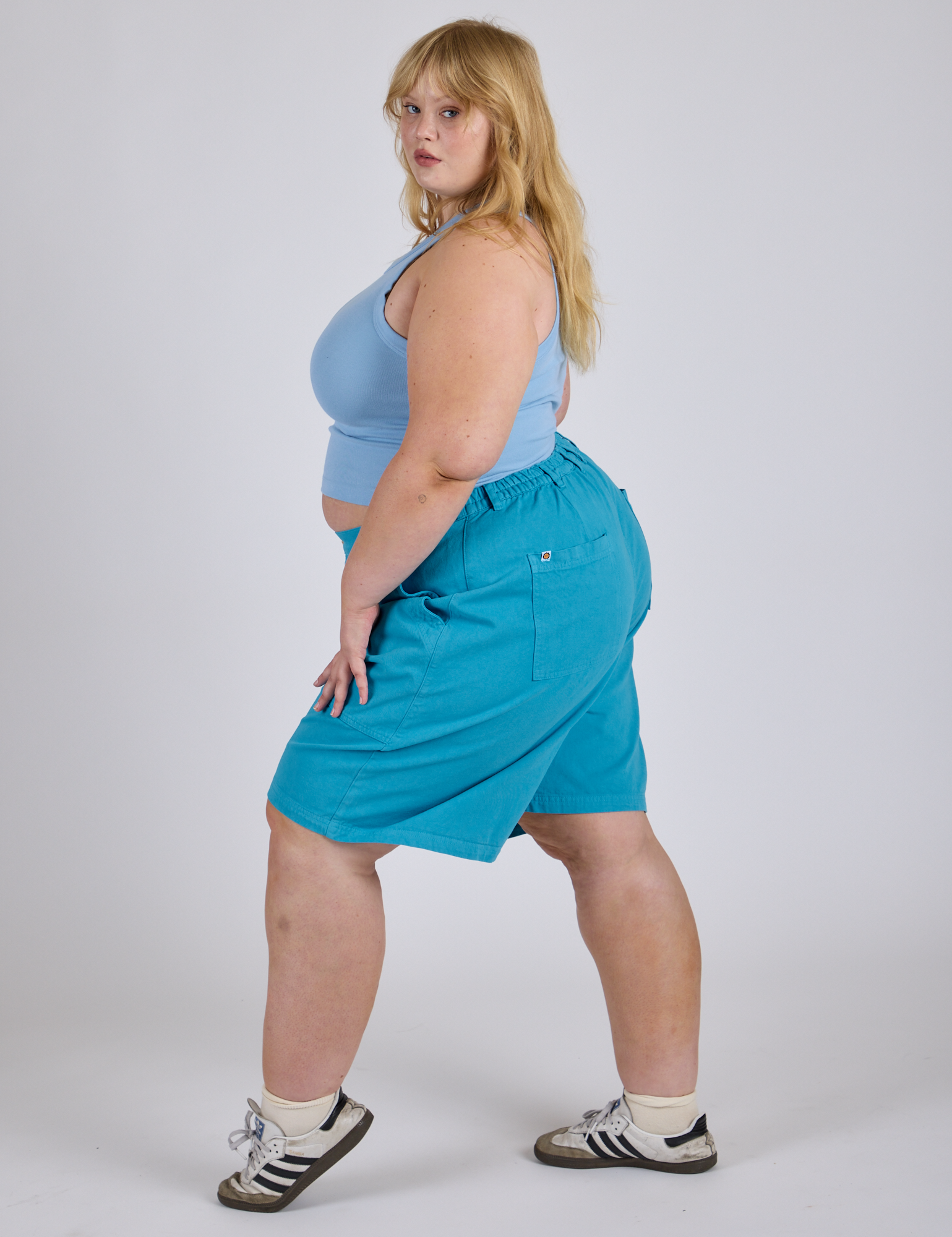 Side view of Longline Work Shorts in Hawaiian Blue and baby blue Racerback Tank on Juliet